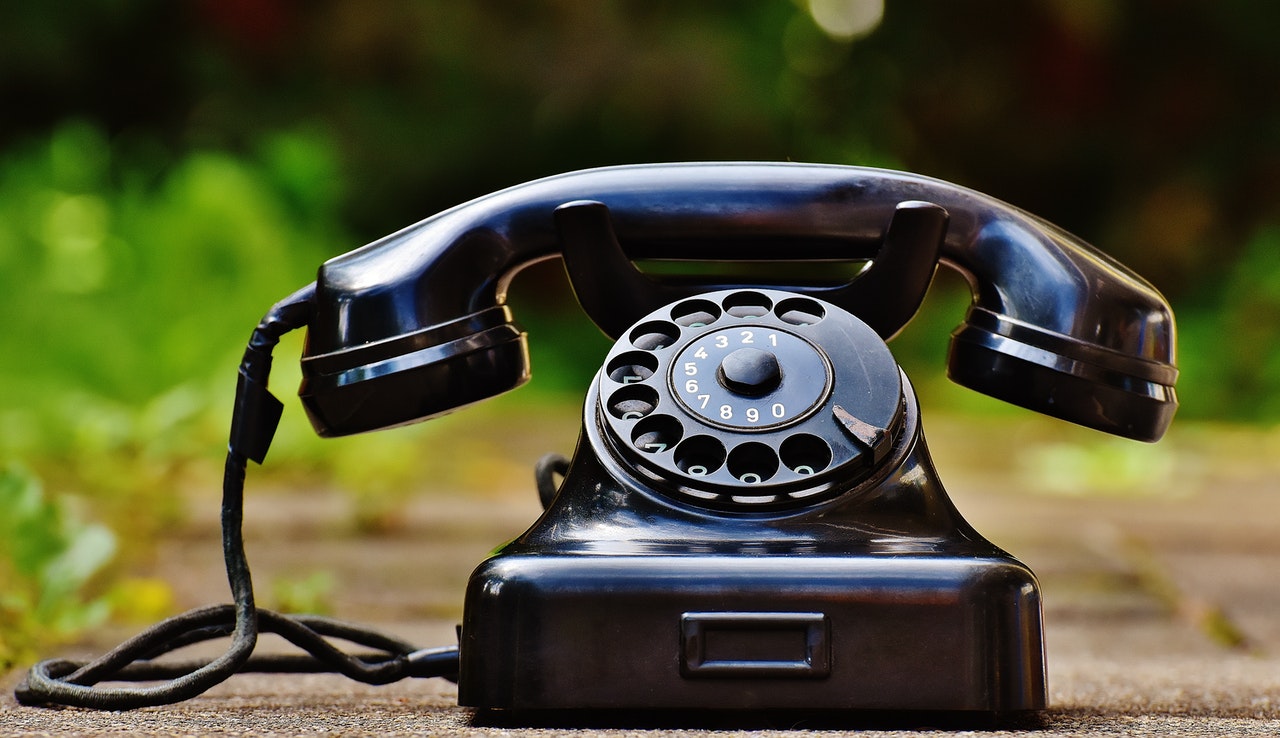 rotary phone on dirt path